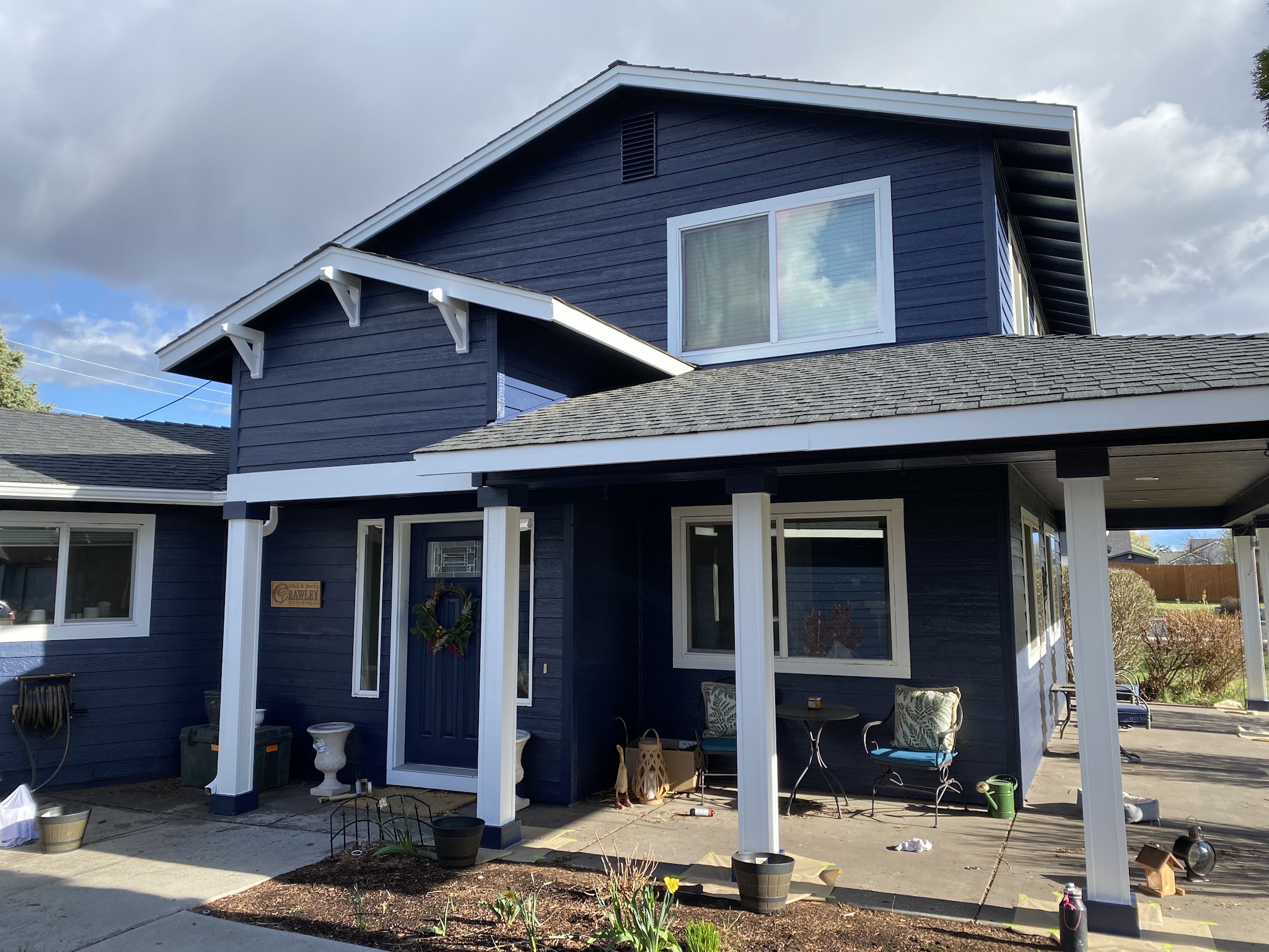 Navy blue craftsman-style home exterior repaint with white trim in Redmond
