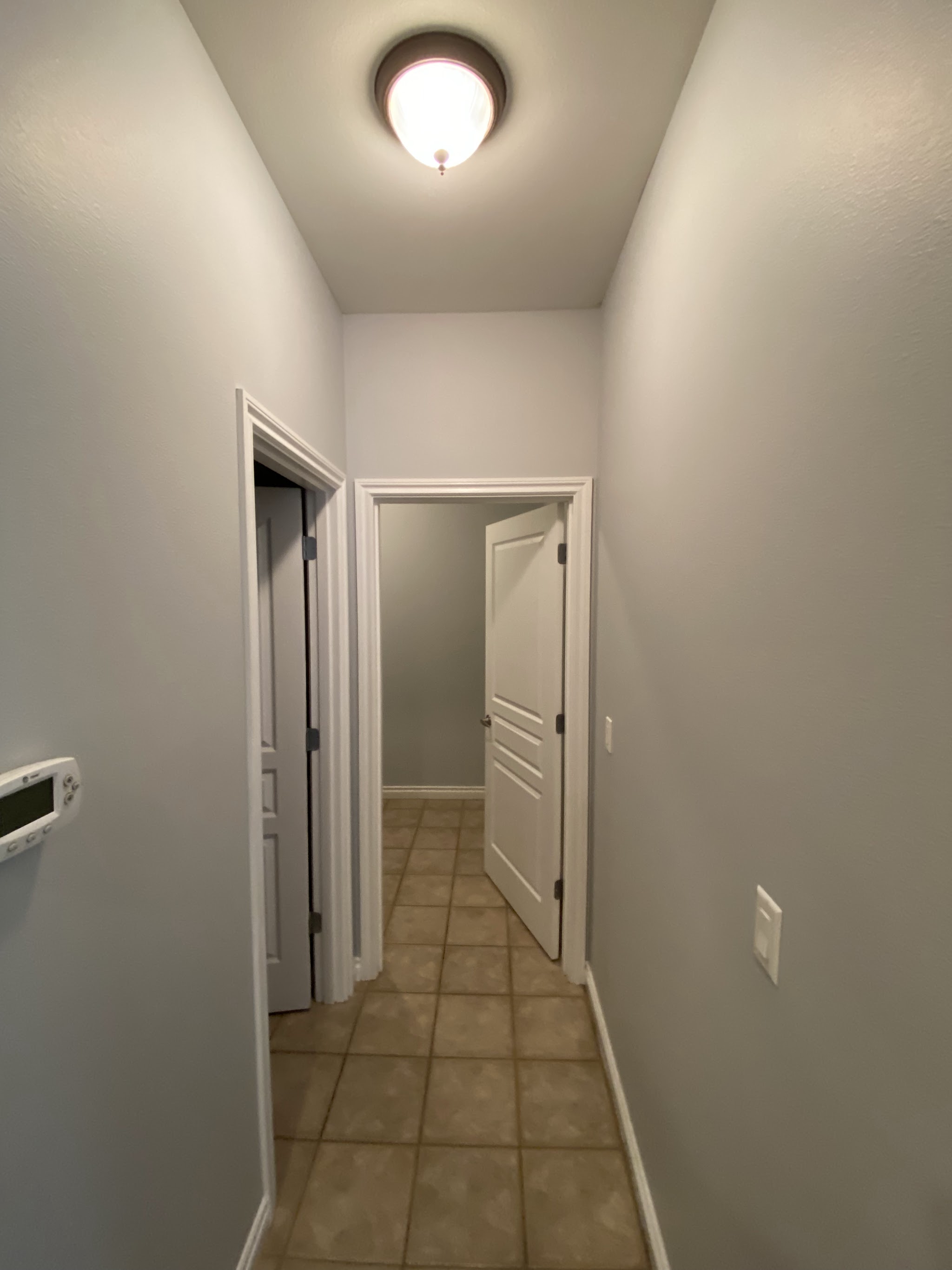 Freshly painted hallway with crisp white trim and doors