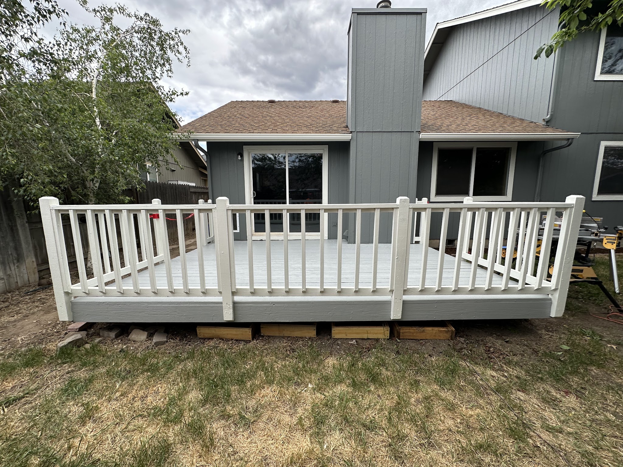 Newly painted deck railing in soft grey and white